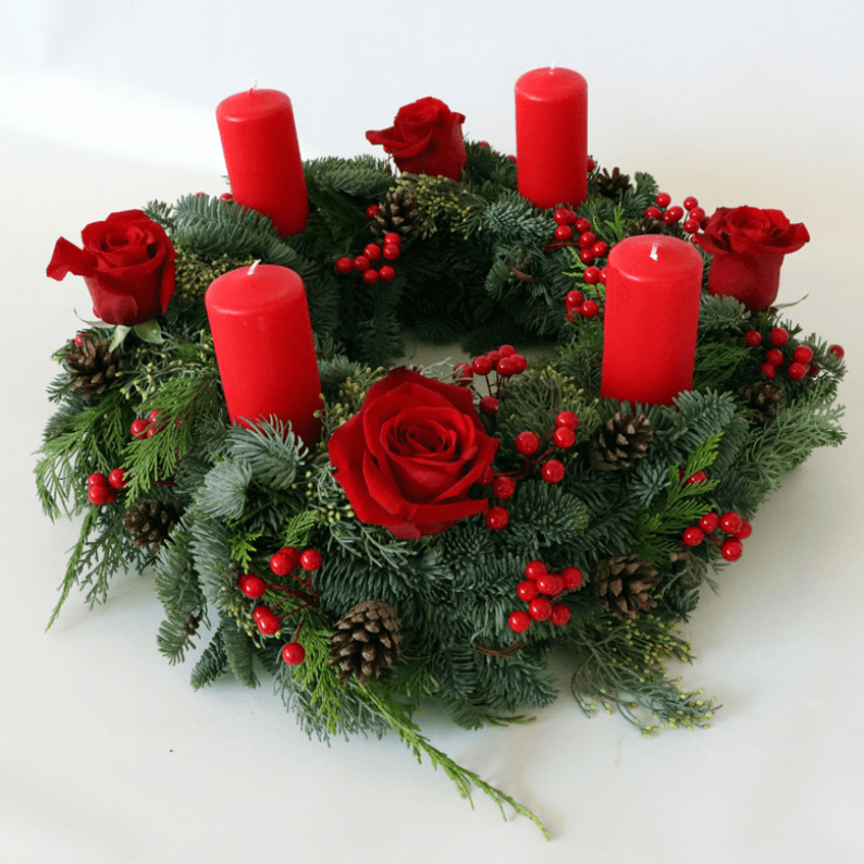 Red Advent Wreath arrangement round wreath with four pillar candles and red roses