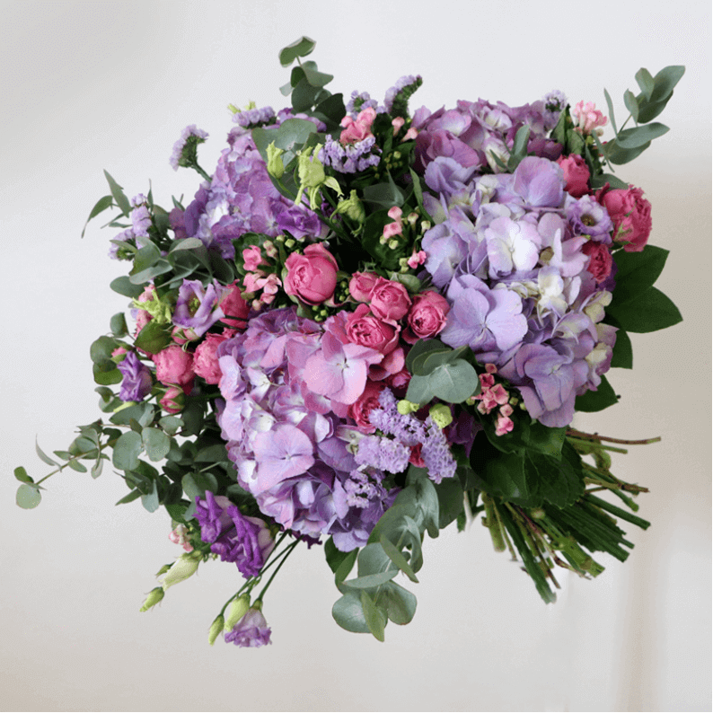 purple mix bouquet Purple hydrangea, pink spray rose and eustoma with greenery in a bouquet