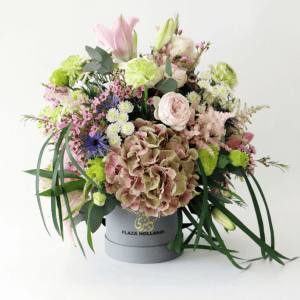 ranunculus, hydrangea, wax flower, eryngium, astilbe, lily arrangement in a Plaza Hollandi Hat Box