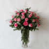 Pink roses in a glass vase with grass and eucalyptus