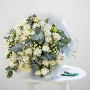 white and green bouquet with prayer beads
