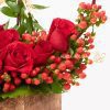 close up of red rose flowers, and hypericum