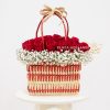 Red and white basket full of roses and gypsophelia flowers