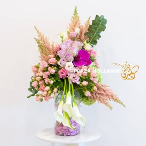 A unique flower arrangement of pink and purple flowers