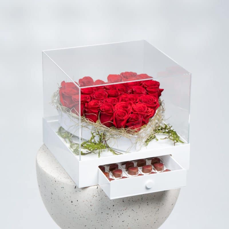 a white box of roses and chocolate