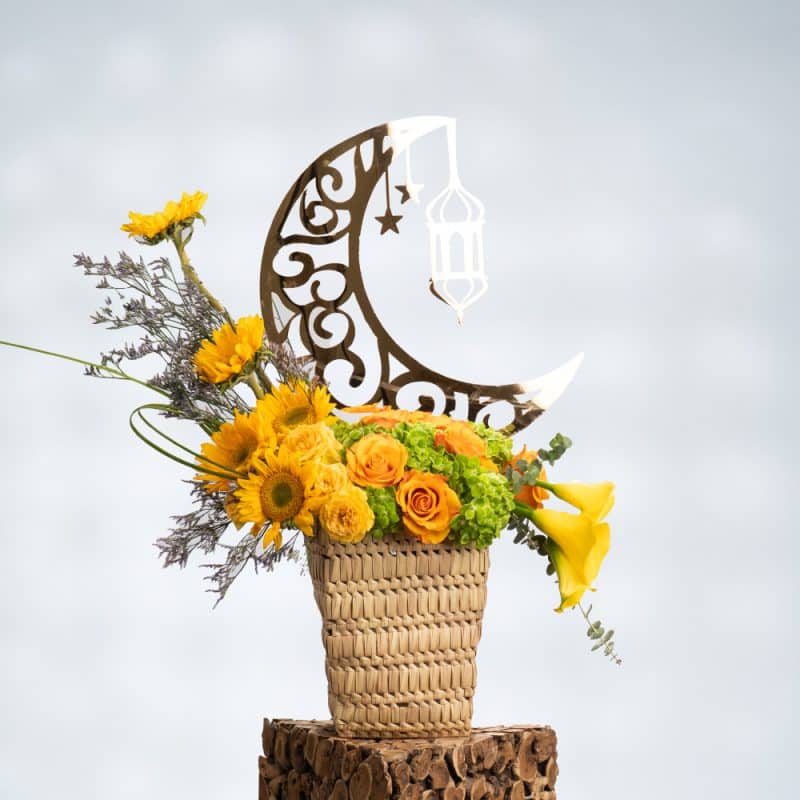 60 cm Yellow Roses, Sunflowers, Yellow Calla Lily, and Green Hydrangea arranged in a stylish reed basket for a fresh and cheerful floral display.