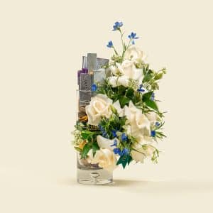 White roses and blue delphinium bouquet with chocolates